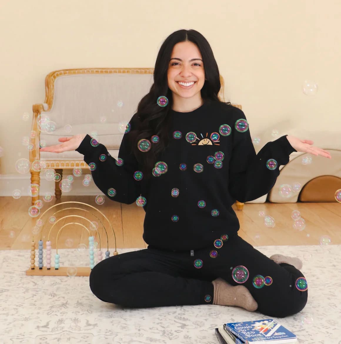 Jessica sitting with therapy toys and bubbles